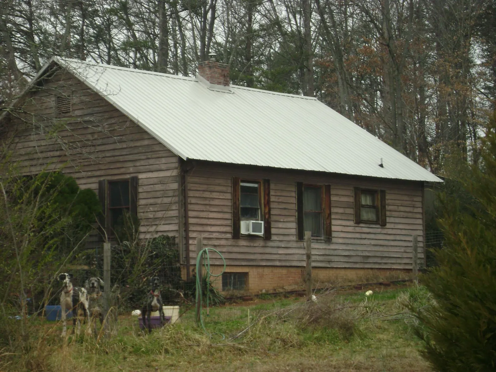 White metal roof on an old wood sided farmhouse, from a Metal Roof Installation job in Delaplane